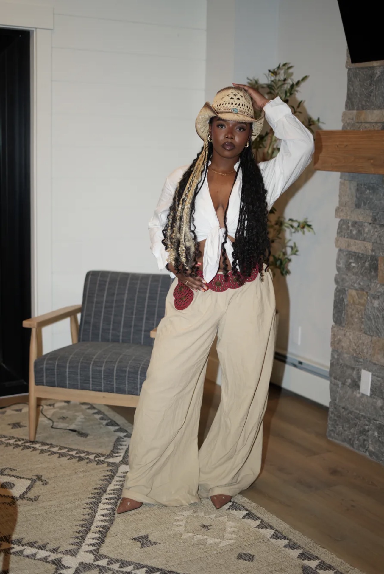 Woman in cowboy hat and wide leg pants
