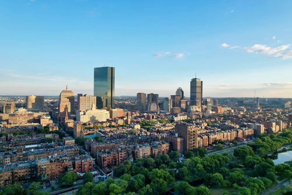 Aerial view of Boston's Back Bay skyline with the Charles River and brownstone rowhouses